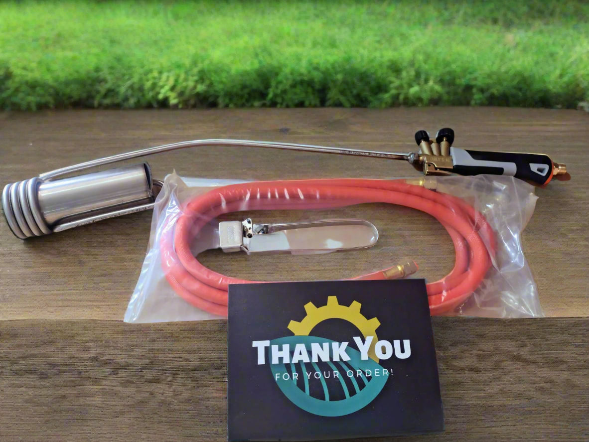 Pistol grip torch with hose and accessories on a cardboard box with a 'Thank You' card.