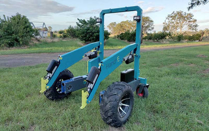 Electric farm loader carrying a load