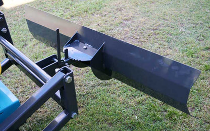 Blade attachment clearing a driveway