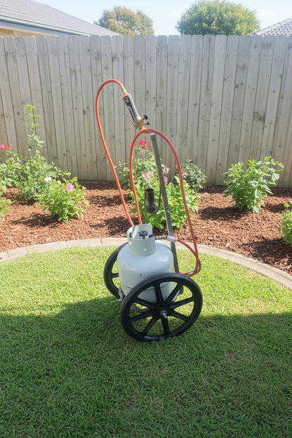 Gas bottle trolley with a Weed Wand PRO weed burner hanging on the hook and an 8.5kg LPG bottle strapped on